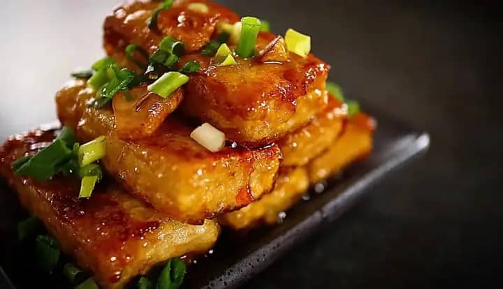 Warm Asian specialty served on a black plate