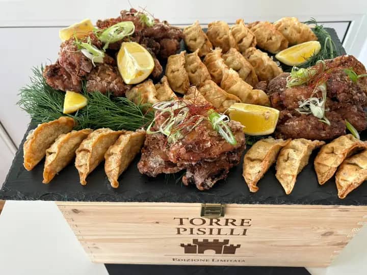 Platter with gyoza and crispy warm snacks